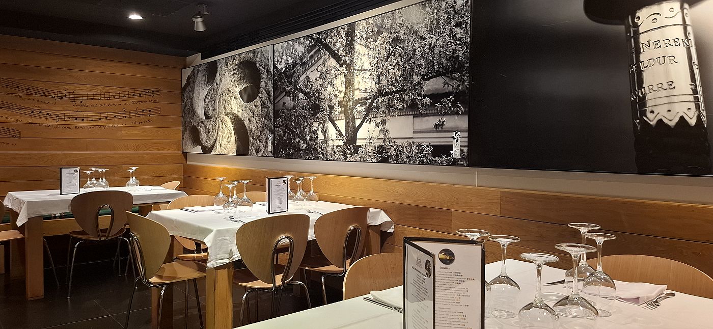 The dining room, with its tables laid and the black-and-white photographs on the wall